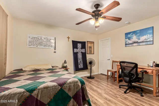 a bedroom that has a bed and a chair in it