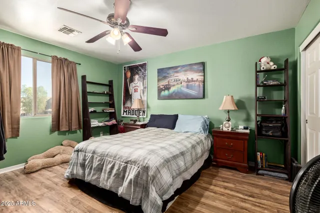 a bedroom with a bed dresser and a window
