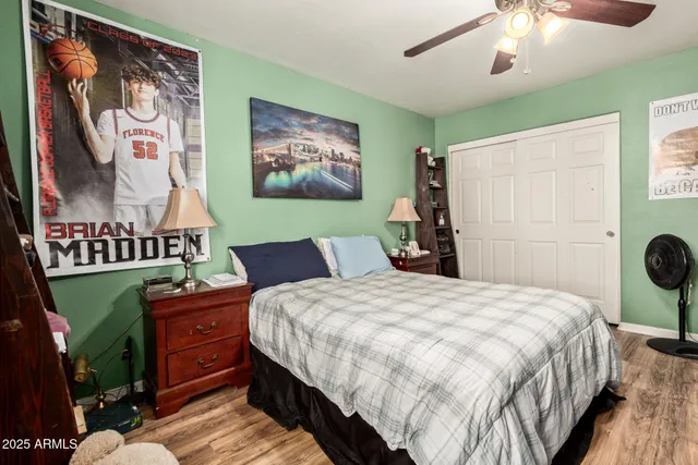 a bedroom with a bed and a chandelier