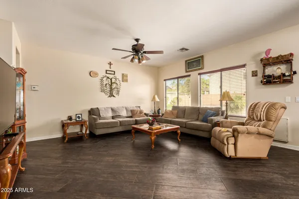 a living room with furniture window and a flat screen tv