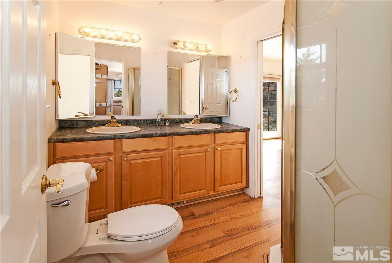 90 Bobcat Hill Road Reno, NV 89508 - Photo 13 of 24 a bathroom with a granite countertop toilet a sink and a mirror
