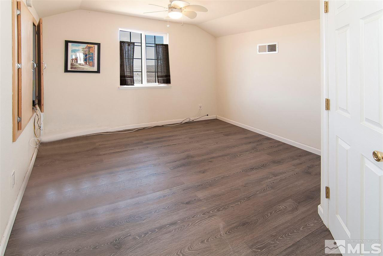 90 Bobcat Hill Road Reno, NV 89508 - Photo 17 of 24 a view of an empty room with wooden floor and a window