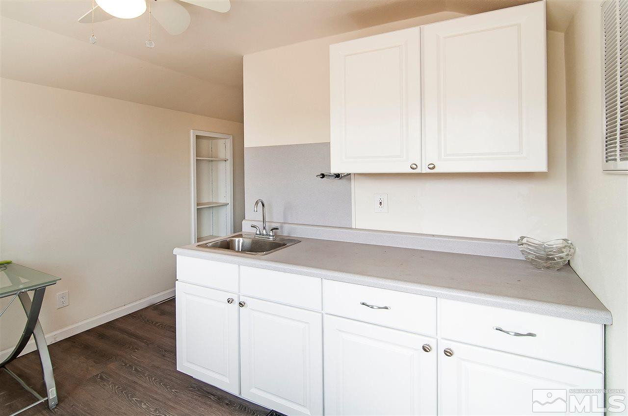 90 Bobcat Hill Road Reno, NV 89508 - Photo 18 of 24 a kitchen with granite countertop white cabinets and a sink