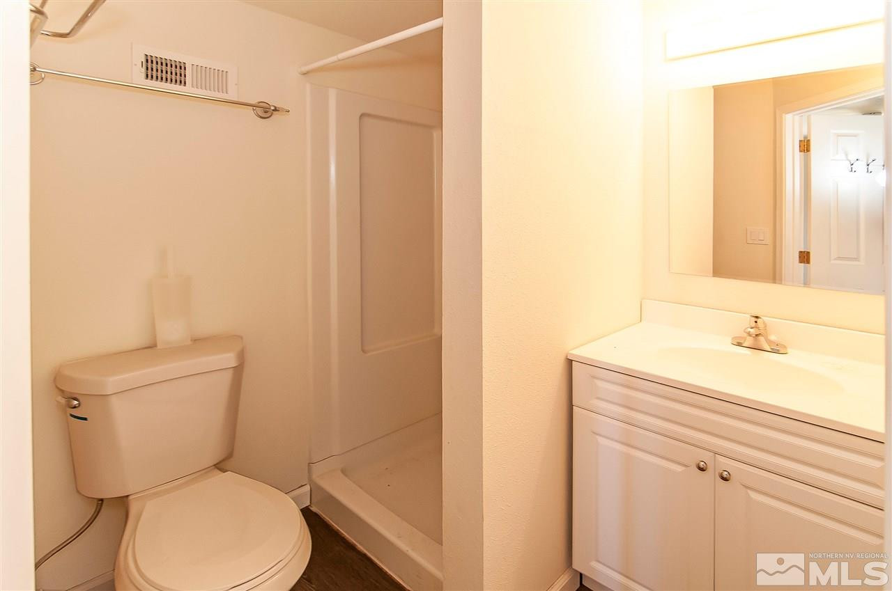90 Bobcat Hill Road Reno, NV 89508 - Photo 19 of 24 a bathroom with a toilet a sink and a mirror