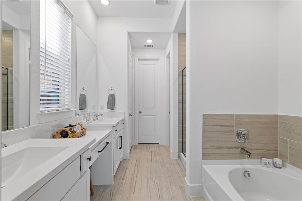 1332 Thompson Road Argyle, TX 76226 - Photo 16 of 36 Full bathroom featuring double vanity, a stall shower, a garden tub, and recessed lighting