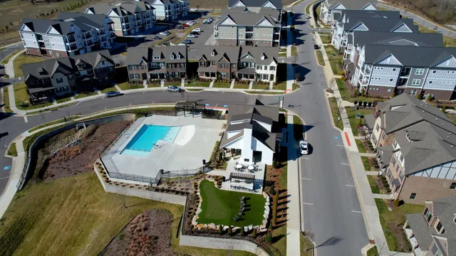a view of a hallway with wooden floor and stairs