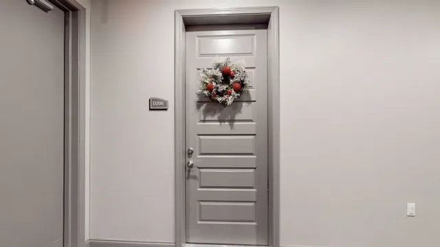 a view of a hallway with wooden floor and entryway