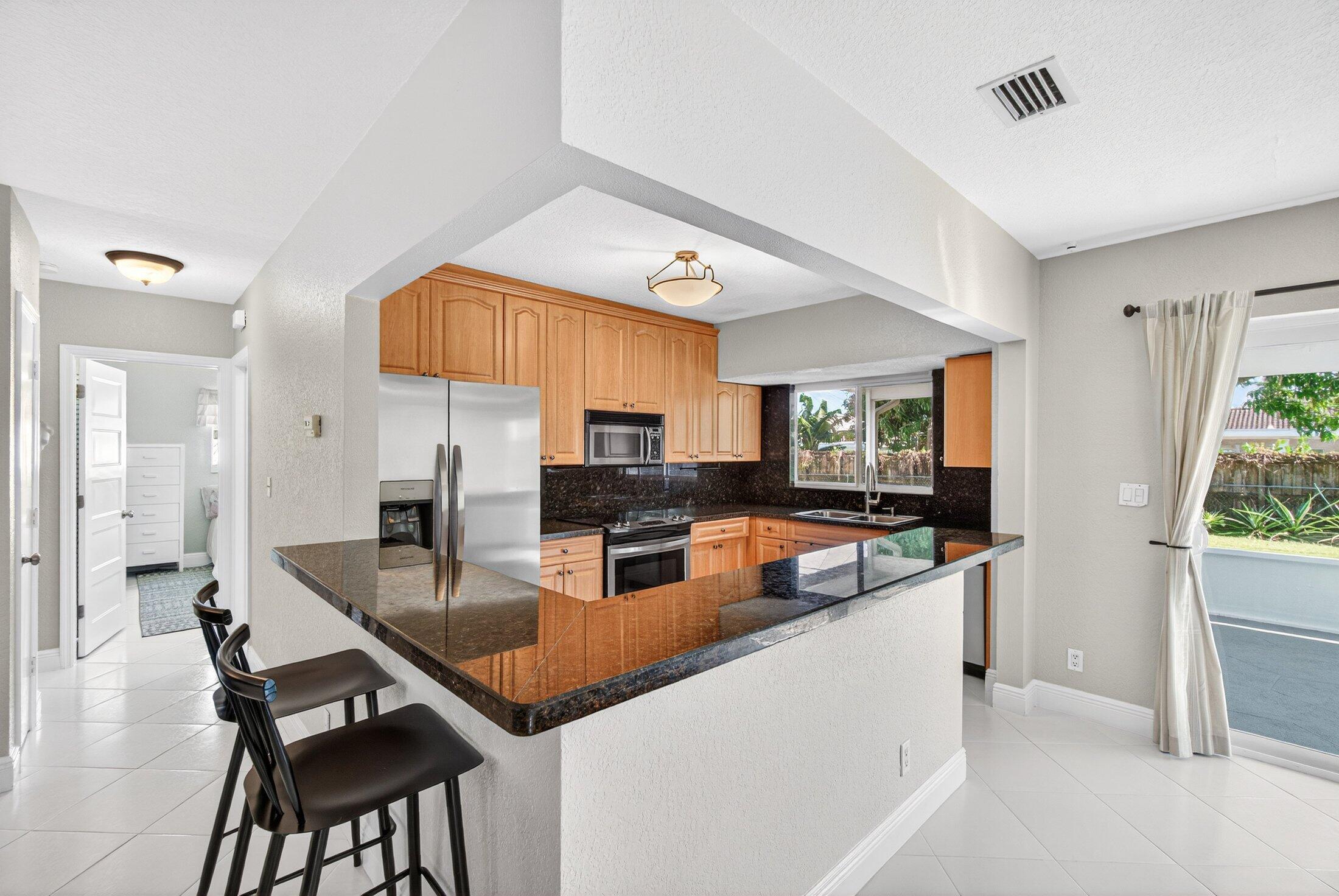 1200 Southwest 12th Terrace Boca Raton, FL 33486 - Photo 10 of 29 Kitchen with bar counter