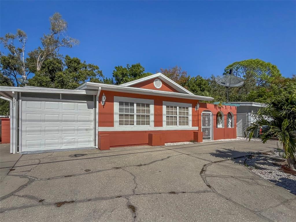 3957 Proctor Road Sarasota, FL 34233 - Photo 1 of 18 a front view of a house with a yard