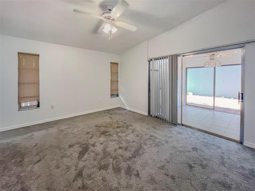 3957 Proctor Road Sarasota, FL 34233 - Photo 6 of 18 an empty room with windows and fan