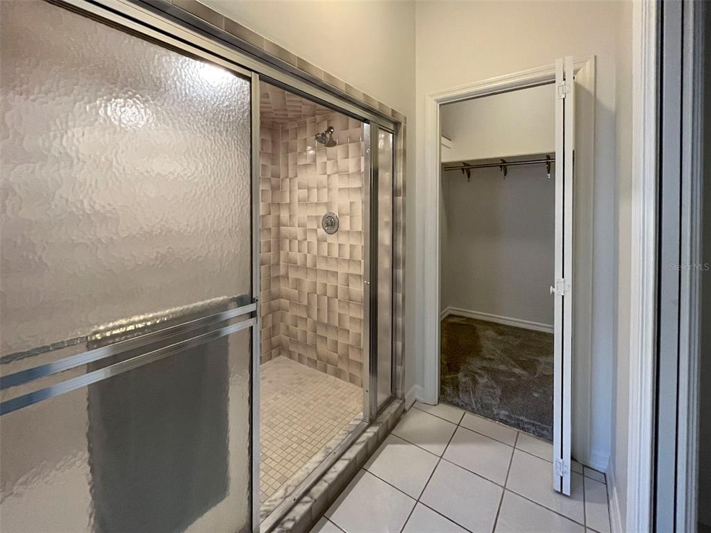 3957 Proctor Road Sarasota, FL 34233 - Photo 9 of 18 a bathroom with a glass shower door
