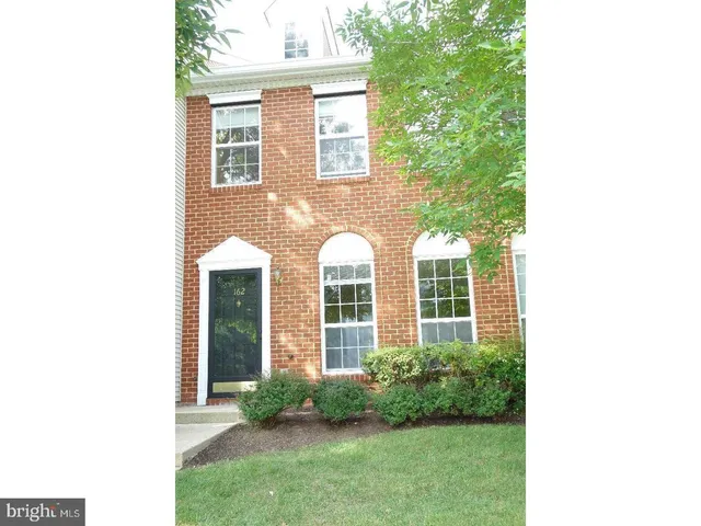 a view of a brick house with a large windows