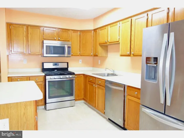 a kitchen with a refrigerator stove and microwave