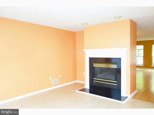 a room with a bed and a dresser