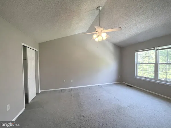 a large kitchen with a stove and a refrigerator