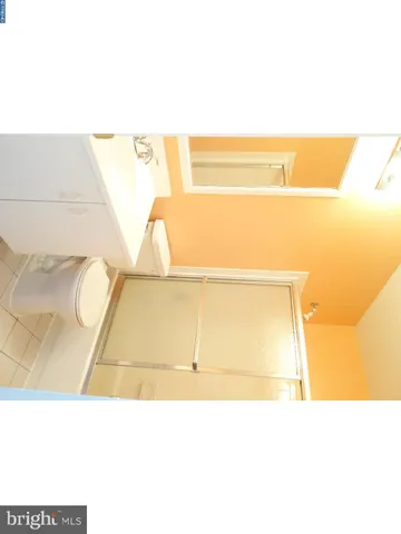 a view of a room with a window and a ceiling fan