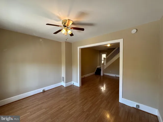 a view of empty room with wooden floor