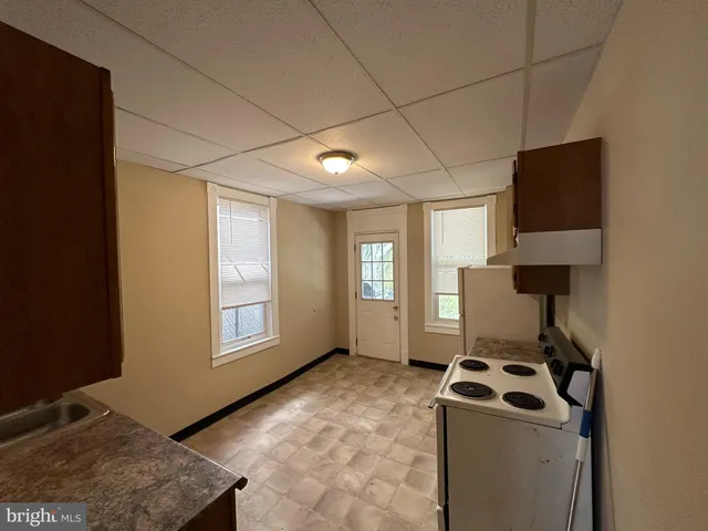 a kitchen that has a sink and a stove