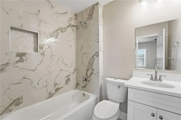 a bathroom with a sink toilet a bathtub and shower