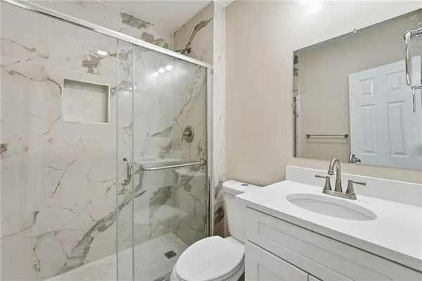 a bathroom with a sink toilet and shower