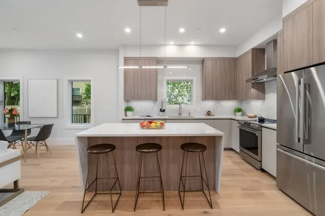 a kitchen with kitchen island a sink table and chairs