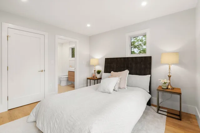 a bedroom with a bed and a night stand