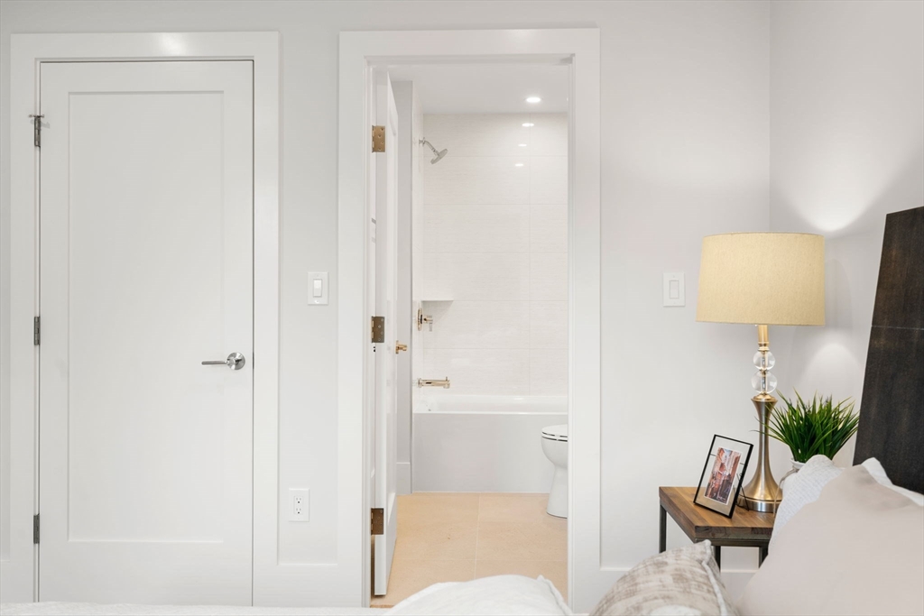 2202 Commonwealth Avenue, Unit 2 Newton, MA 02466 - Photo 15 of 23 a living room with furniture and a lamp