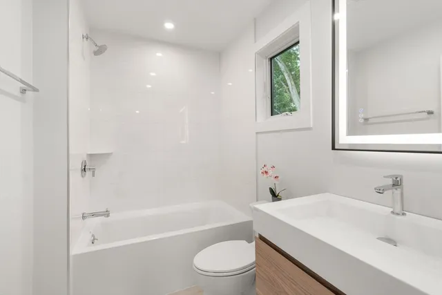 a bathroom with a sink toilet and shower