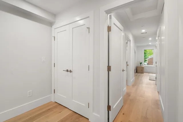 a view of a hallway with wooden floor