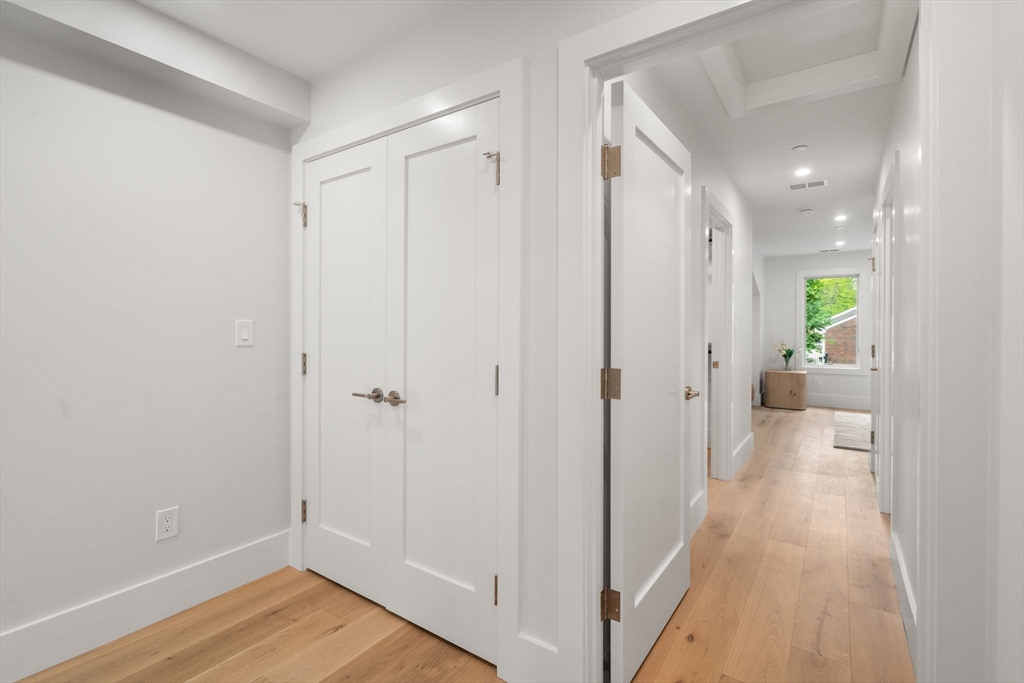 2202 Commonwealth Avenue, Unit 2 Newton, MA 02466 - Photo 17 of 23 a view of a hallway with wooden floor