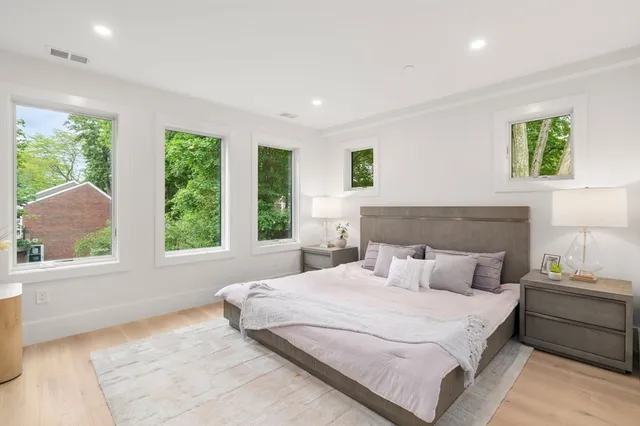 a bedroom with a large bed and a window