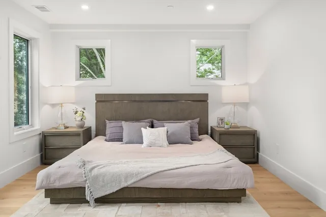 a bedroom with a bed and a painting on the wall