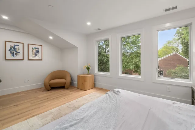 a bedroom with furniture and a window