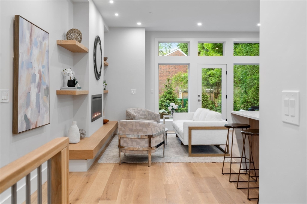 2202 Commonwealth Avenue, Unit 2 Newton, MA 02466 - Photo 3 of 23 a living room with furniture a window and wooden floor