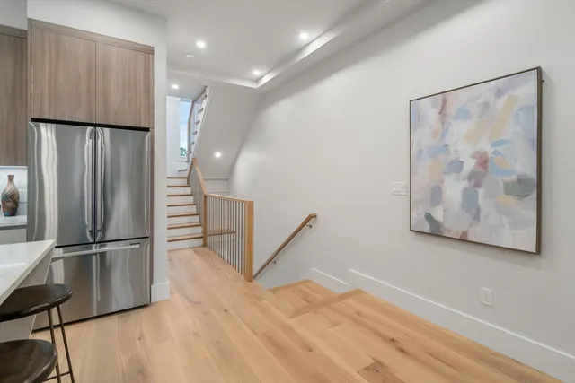 a view of a refrigerator in kitchen and wooden floor