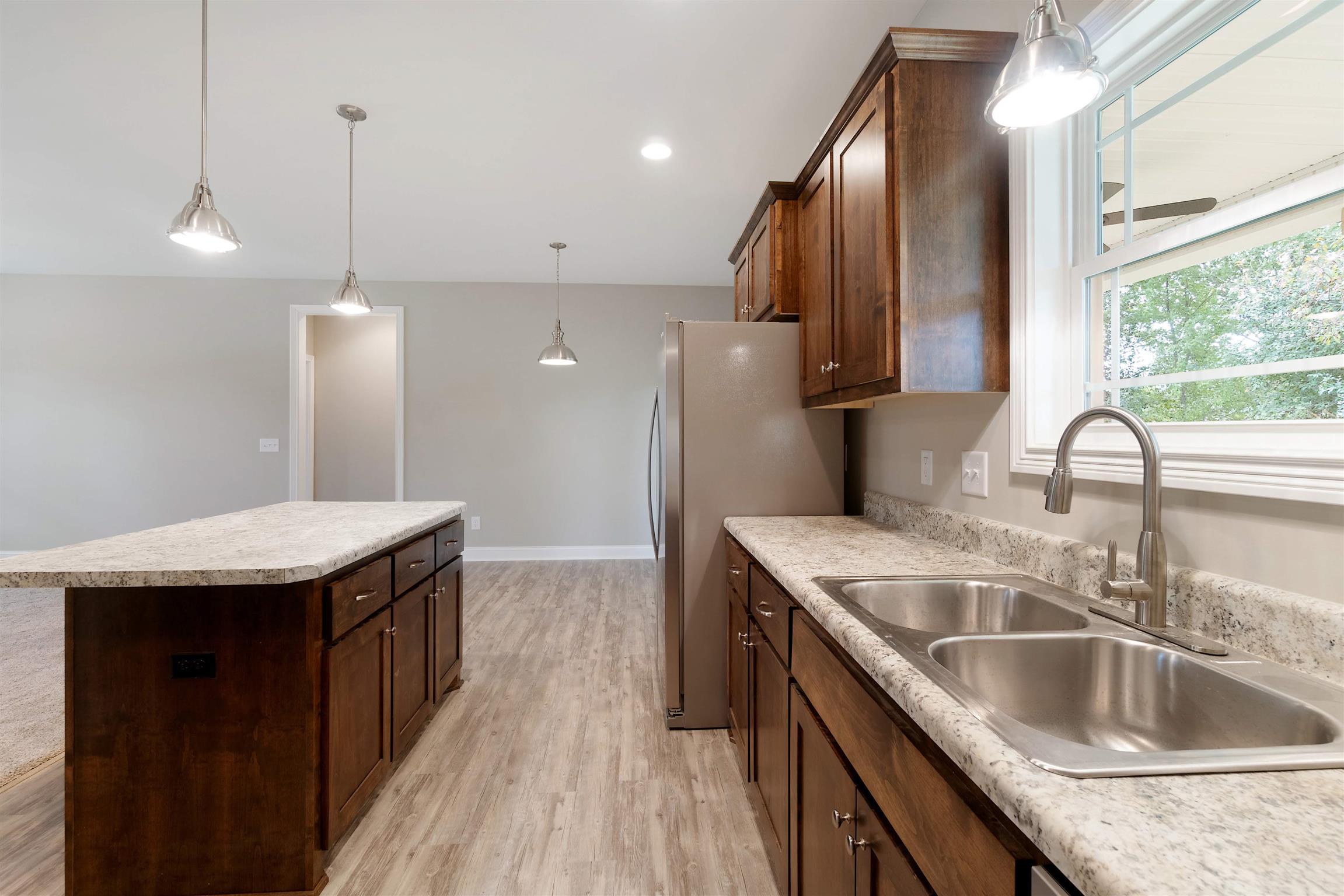 4760 Somerville Road Cross Plains, TN 37049 - Photo 14 of 30 a kitchen with stainless steel appliances granite countertop a sink a oven and a wooden floor