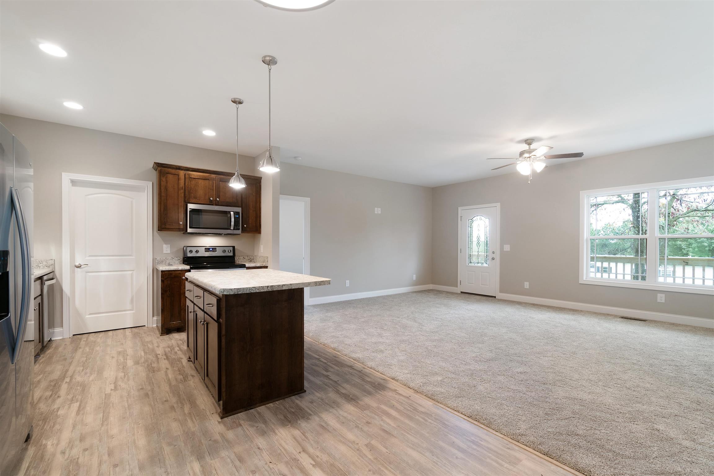 4760 Somerville Road Cross Plains, TN 37049 - Photo 16 of 30 a kitchen with kitchen island a sink wooden floor and stainless steel appliances