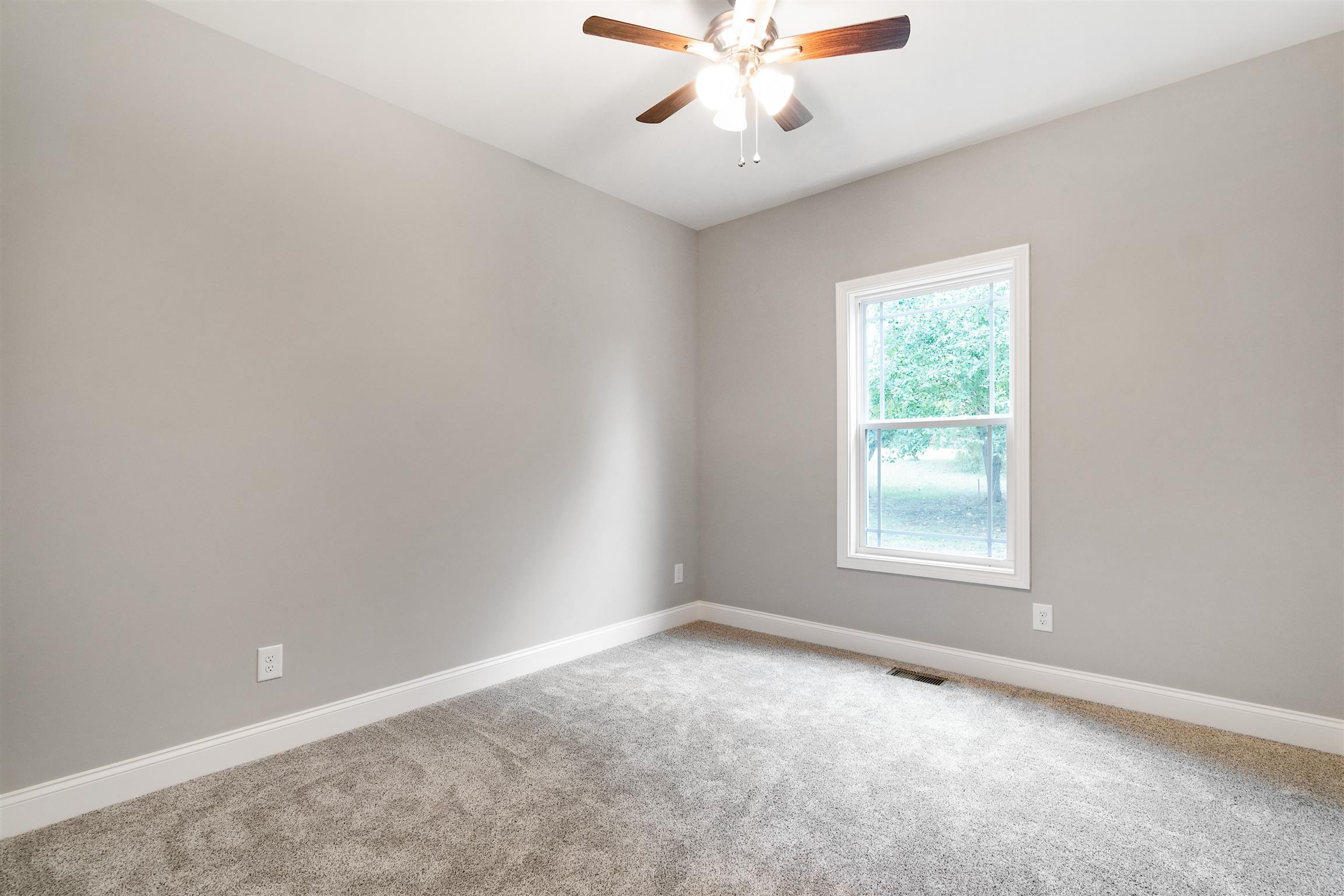 4760 Somerville Road Cross Plains, TN 37049 - Photo 18 of 30 an empty room with a window and a fan