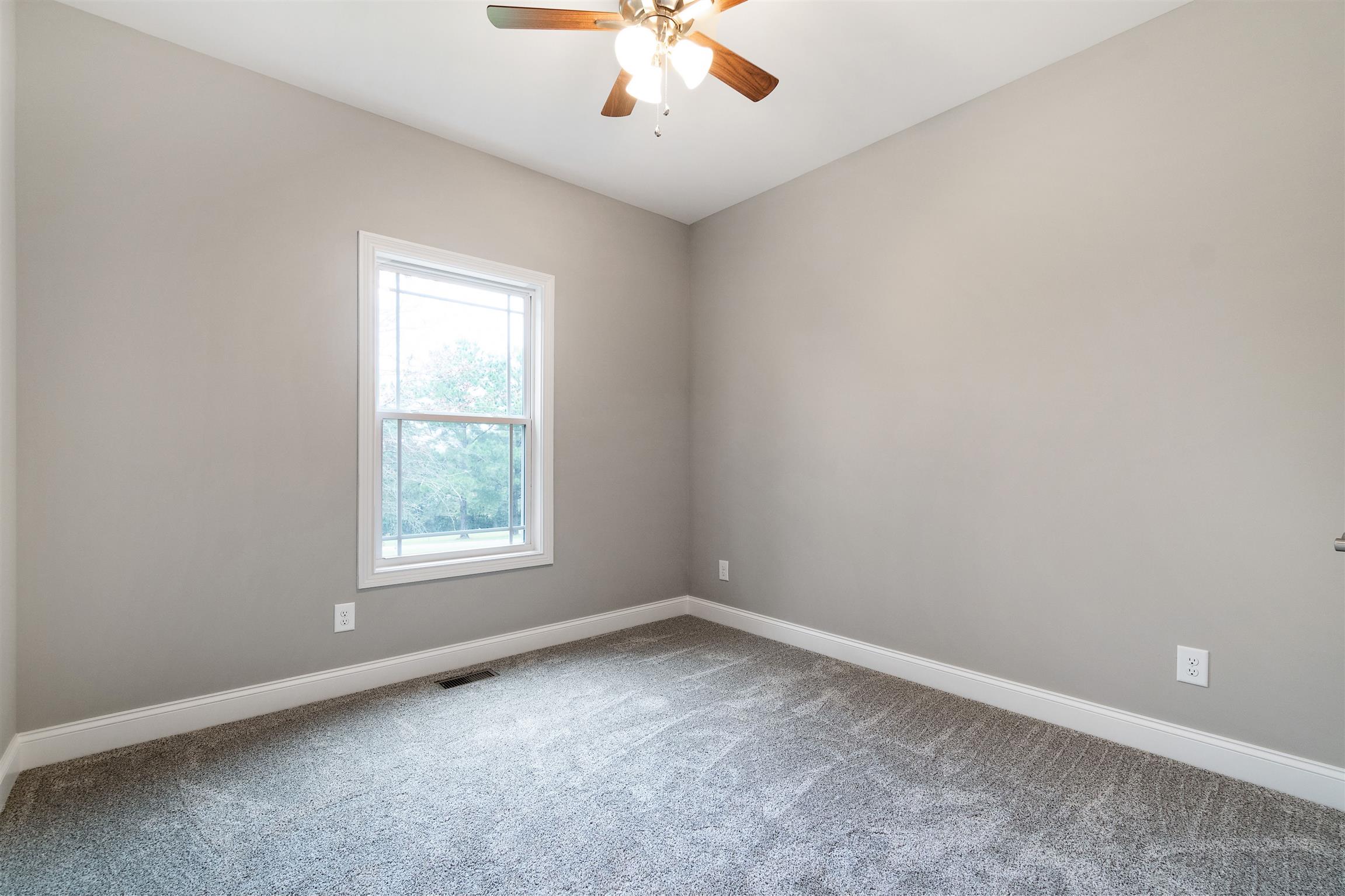 4760 Somerville Road Cross Plains, TN 37049 - Photo 21 of 30 an empty room with a window and a ceiling fan