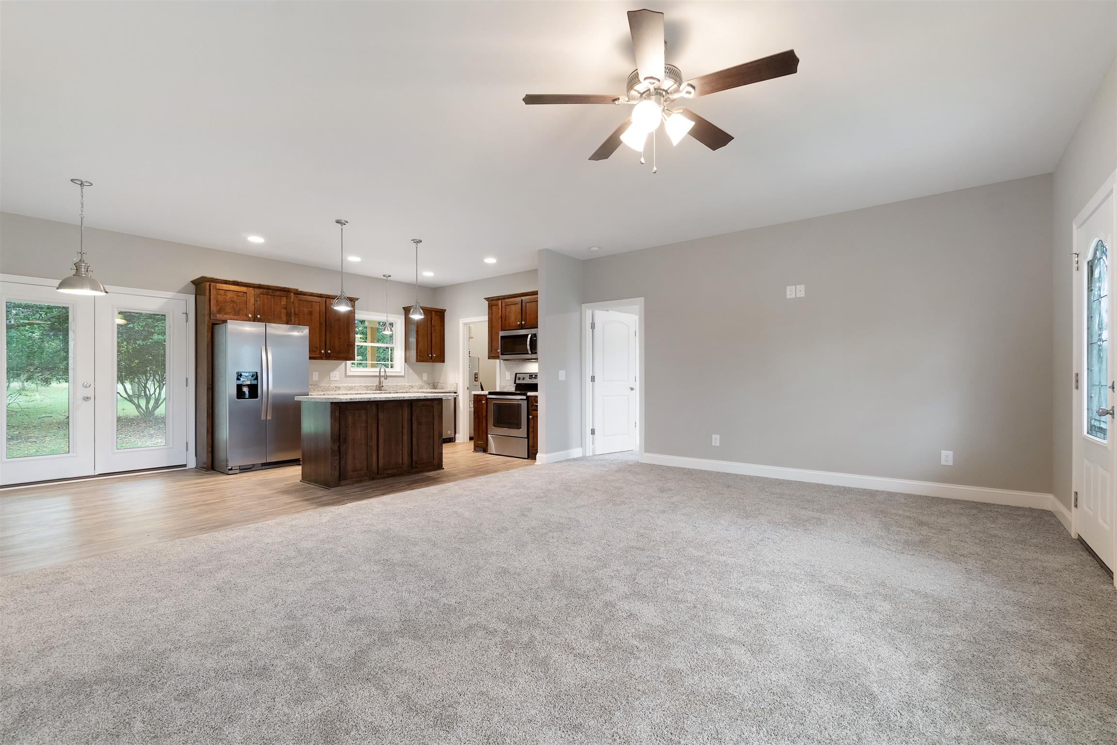 4760 Somerville Road Cross Plains, TN 37049 - Photo 8 of 30 a view of a kitchen with a stove cabinets a ceiling fan and wooden floor