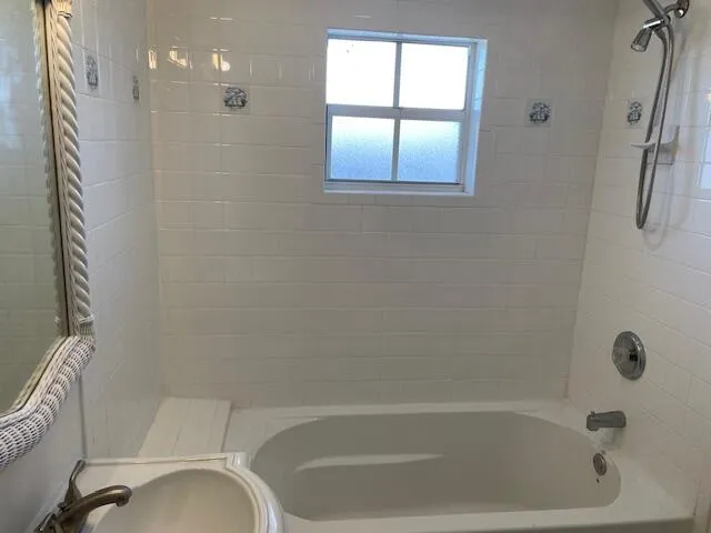 a bath tub sitting next to a window