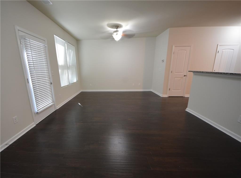 5873 Taka Lane Lithonia, GA 30038 - Photo 12 of 26 an empty room with wooden floor cabinet and windows