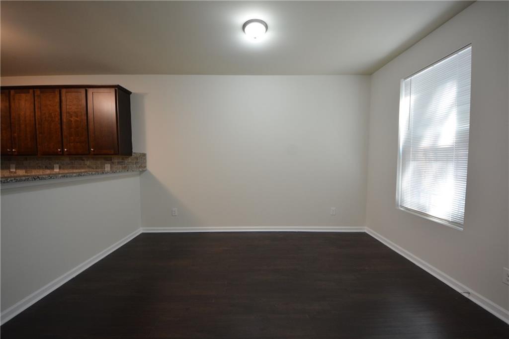 5873 Taka Lane Lithonia, GA 30038 - Photo 13 of 26 an empty room with wooden floor and windows