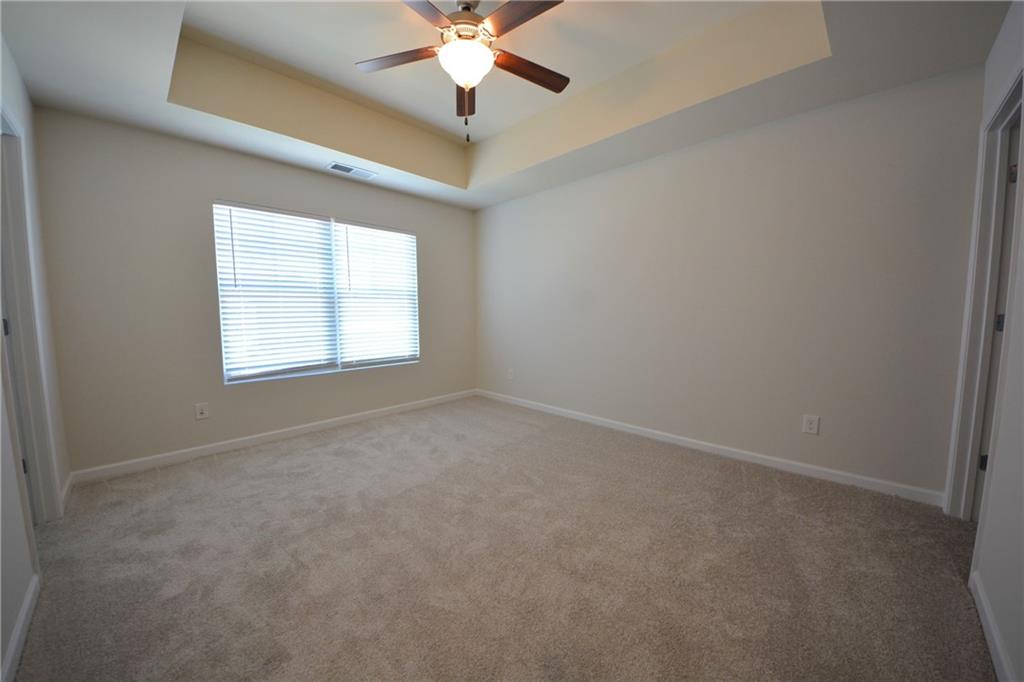 5873 Taka Lane Lithonia, GA 30038 - Photo 18 of 26 an empty room with a window and a fan