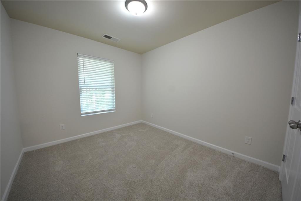 5873 Taka Lane Lithonia, GA 30038 - Photo 21 of 26 an empty room with a window