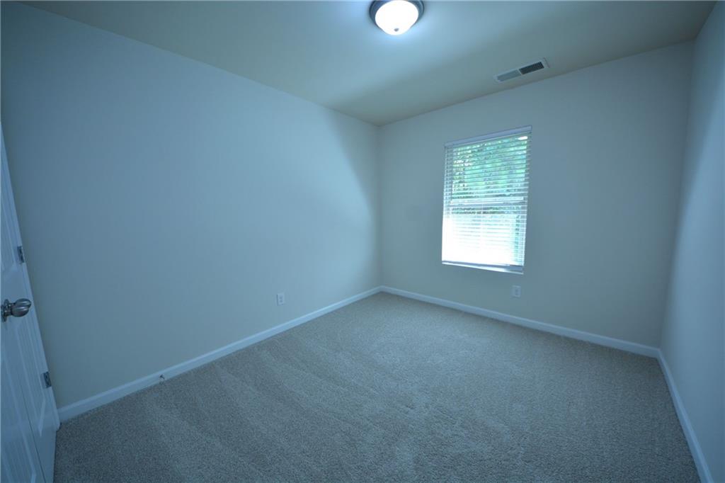 5873 Taka Lane Lithonia, GA 30038 - Photo 24 of 26 an empty room with a window