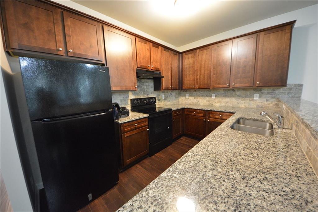 5873 Taka Lane Lithonia, GA 30038 - Photo 8 of 26 a kitchen with a refrigerator sink and cabinets
