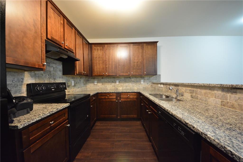 5873 Taka Lane Lithonia, GA 30038 - Photo 9 of 26 a kitchen with granite countertop a sink and a stove