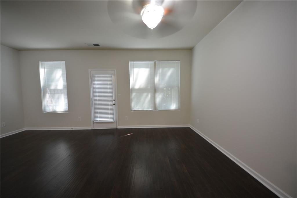 5873 Taka Lane Lithonia, GA 30038 - Photo 10 of 26 an empty room with wooden floor and windows