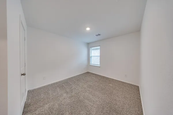 a view of an empty room and a window